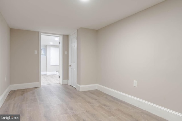 empty room with light hardwood / wood-style flooring