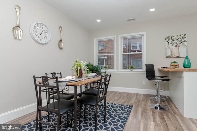 dining area with hardwood / wood-style floors