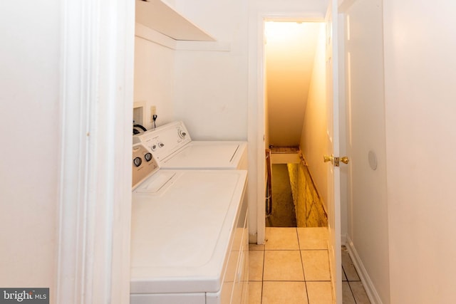 laundry area featuring light tile patterned floors and independent washer and dryer