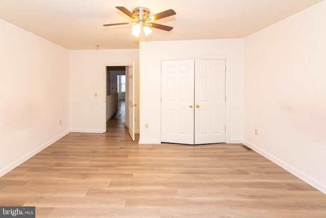 unfurnished bedroom with a closet, ceiling fan, and light hardwood / wood-style flooring