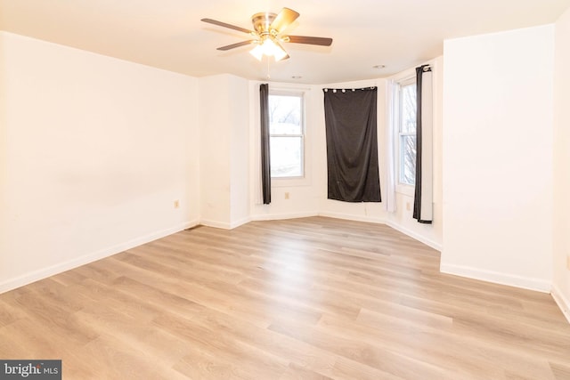 unfurnished room featuring ceiling fan and light wood-type flooring