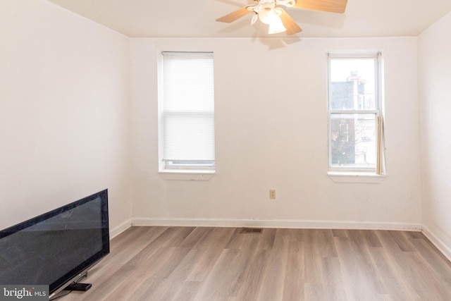 unfurnished room with light hardwood / wood-style flooring and ceiling fan