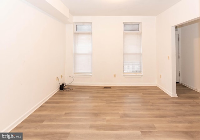 spare room featuring light hardwood / wood-style floors