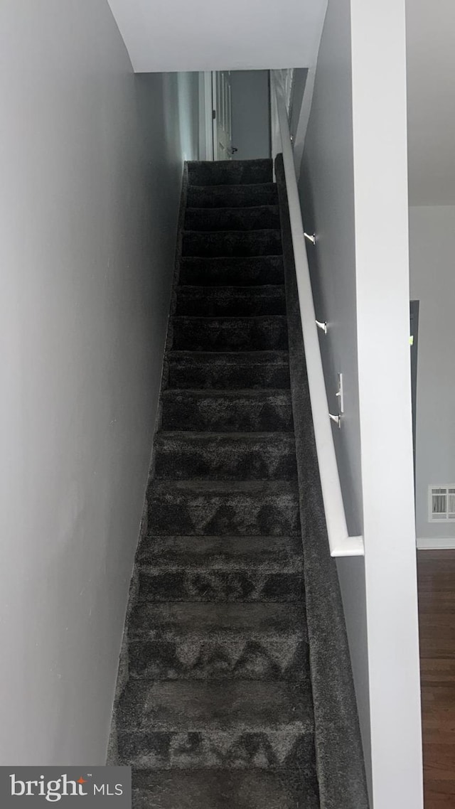 staircase featuring hardwood / wood-style floors