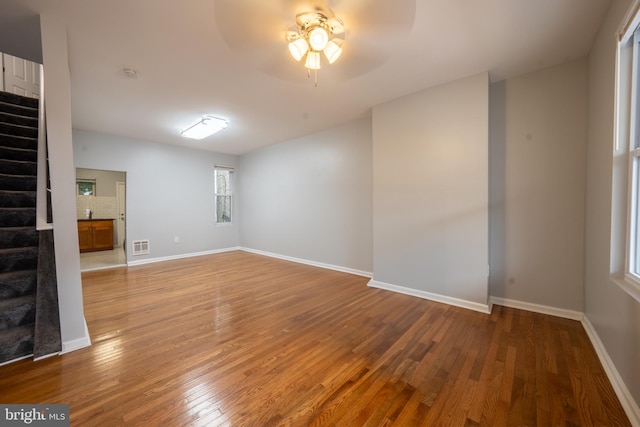 empty room featuring wood-type flooring and ceiling fan