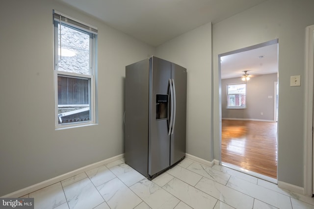 kitchen featuring ceiling fan and stainless steel fridge with ice dispenser