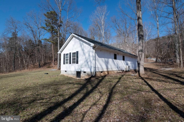 view of property exterior with crawl space and a lawn