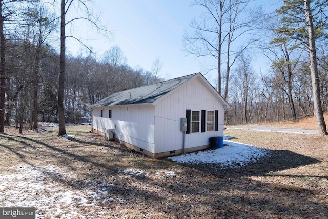 view of side of home featuring crawl space