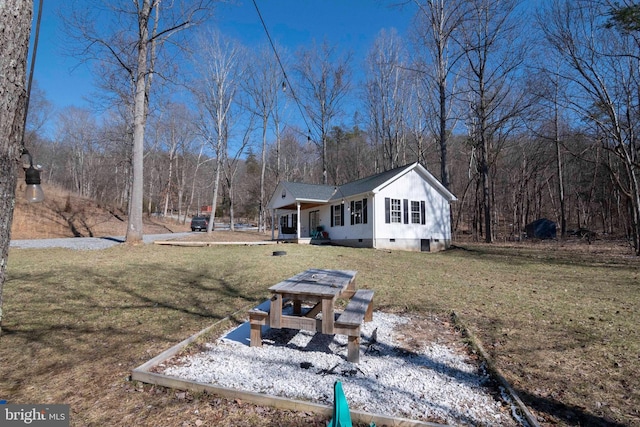 exterior space featuring crawl space and a lawn