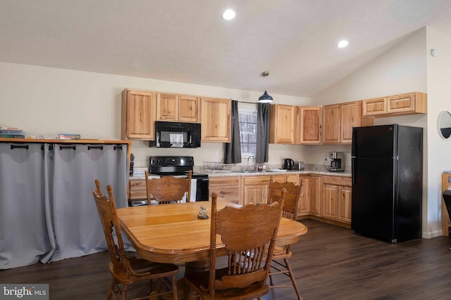 kitchen with dark wood finished floors, lofted ceiling, light countertops, a sink, and black appliances