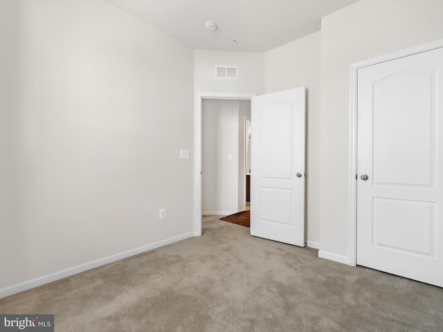 unfurnished bedroom with light carpet