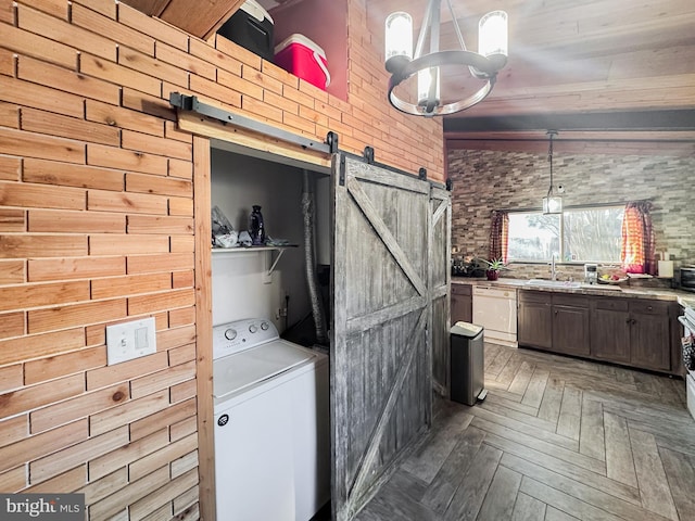 6073 Wycoff Sq, Centreville, VA 20120 - clothes washing area featuring sink, dark parquet floors, brick wall, washer / dryer, and a barn door