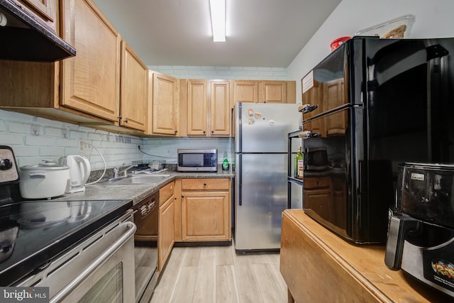 kitchen with light brown cabinetry, sink, backsplash, black appliances, and light hardwood / wood-style flooring