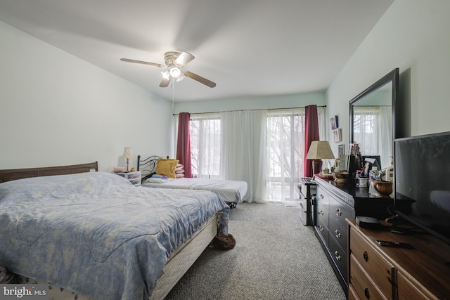 bedroom featuring ceiling fan and carpet