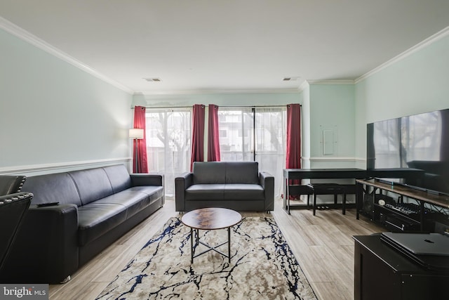 living room featuring crown molding and light wood-type flooring