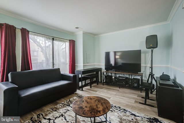 living room featuring crown molding and light hardwood / wood-style floors