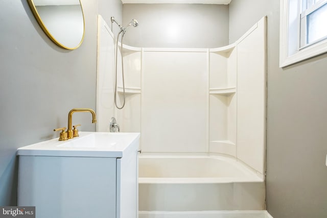 bathroom featuring washtub / shower combination and vanity