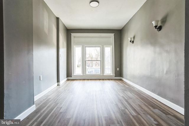 empty room with hardwood / wood-style flooring