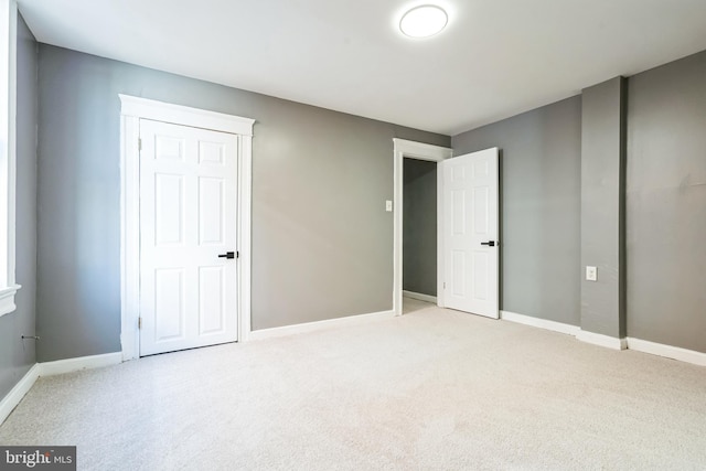 unfurnished bedroom with light colored carpet