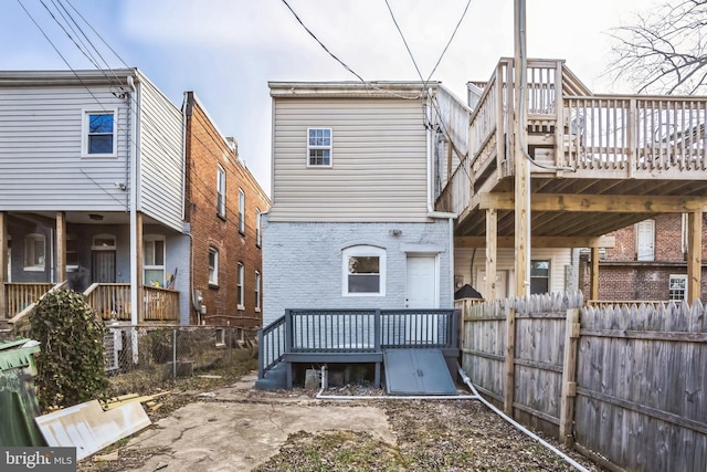 back of house featuring a deck