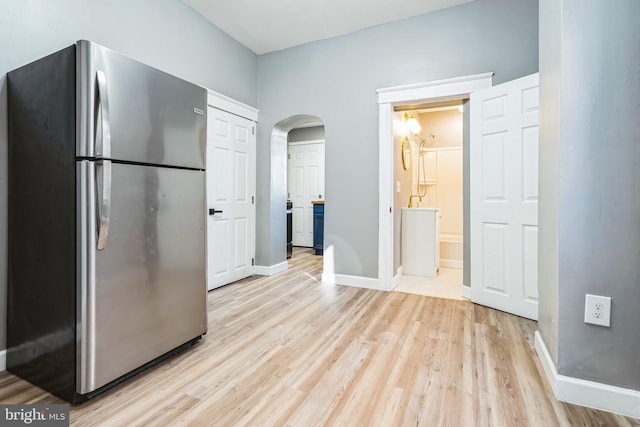 kitchen featuring light wood-type flooring and stainless steel fridge