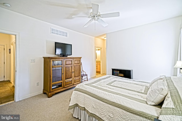 bedroom featuring visible vents, baseboards, a ceiling fan, and carpet flooring