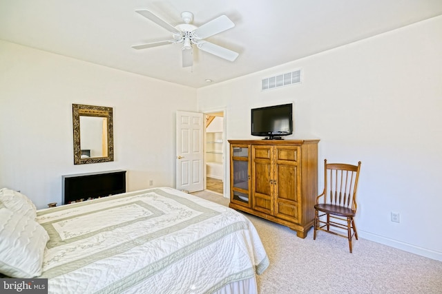 bedroom featuring ceiling fan, light colored carpet, visible vents, and baseboards