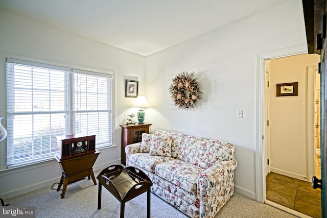 carpeted living room with baseboards