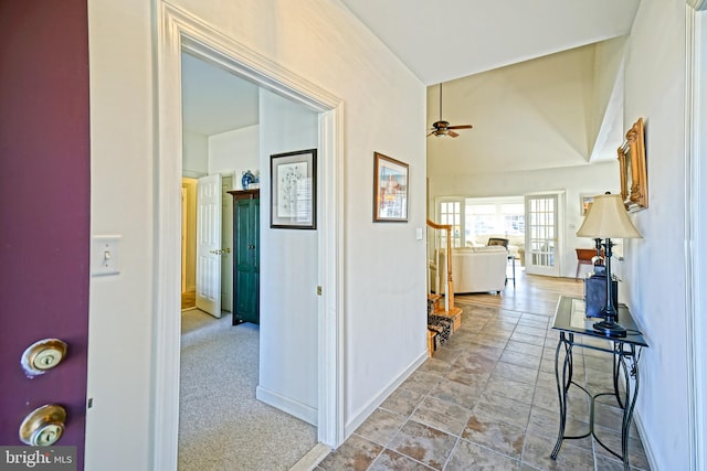 hall featuring carpet and baseboards