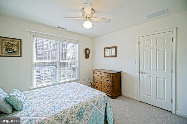 carpeted bedroom with baseboards, visible vents, and ceiling fan