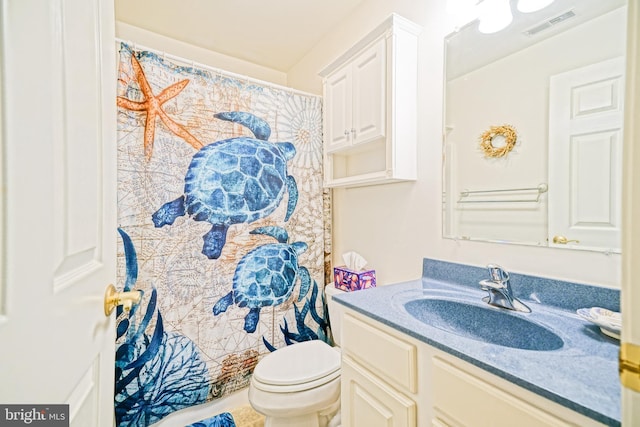 bathroom featuring visible vents, toilet, vanity, and a shower with shower curtain