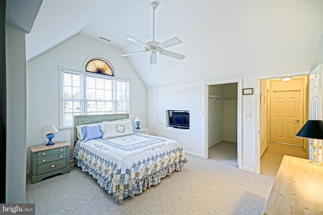 carpeted bedroom with visible vents, ceiling fan, vaulted ceiling, a spacious closet, and a closet