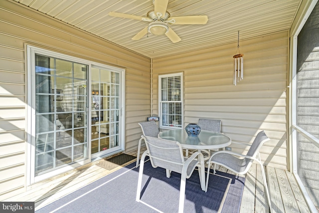 deck with outdoor dining area and a ceiling fan