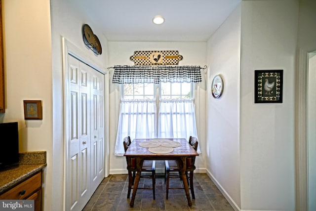 dining space featuring baseboards