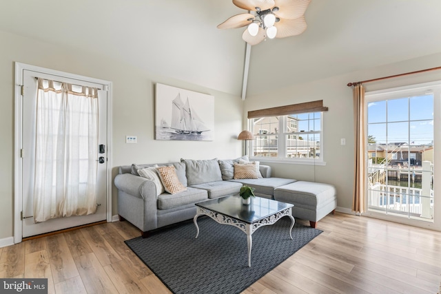 living room featuring vaulted ceiling, ceiling fan, and light hardwood / wood-style floors