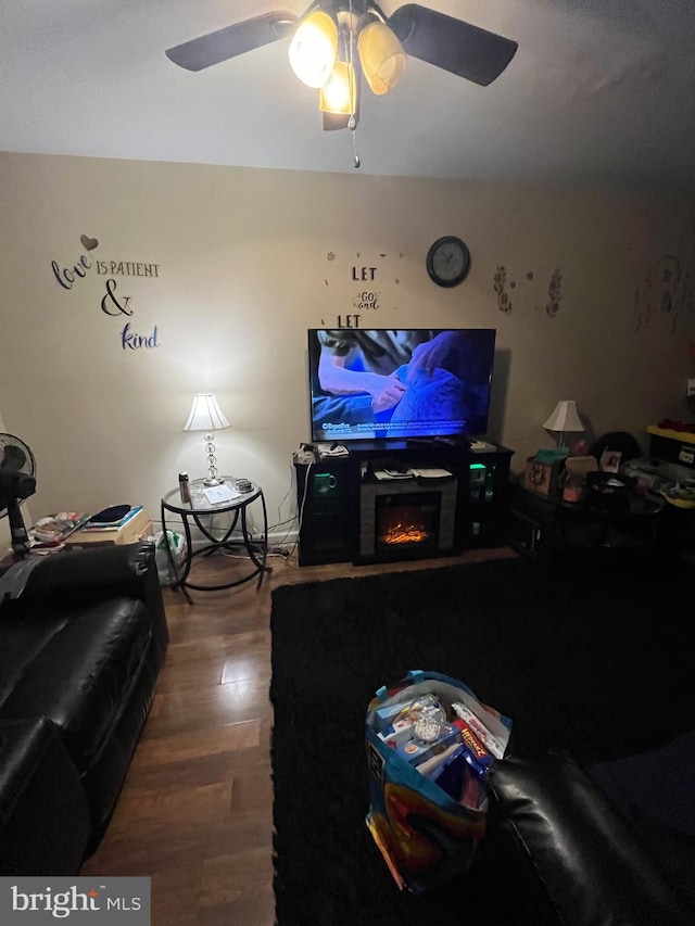 living room featuring wood-type flooring and ceiling fan