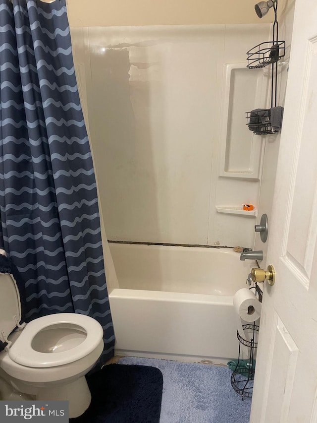 bathroom with shower / bathtub combination with curtain and toilet