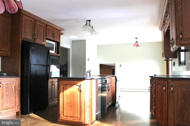 kitchen featuring dark hardwood / wood-style floors and black appliances