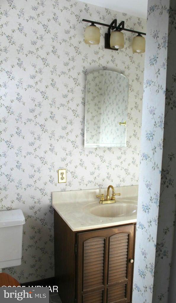 bathroom featuring vanity and toilet