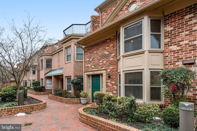 doorway to property with brick siding