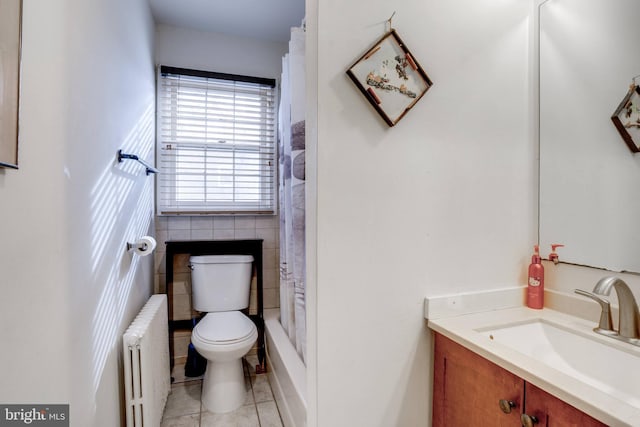 bathroom featuring toilet, radiator heating unit, tile walls, tile patterned floors, and vanity