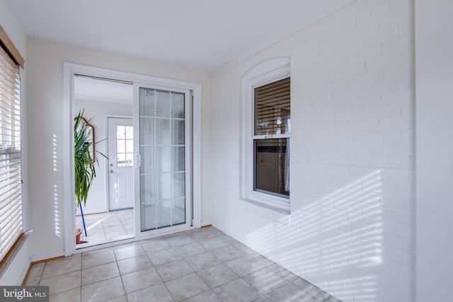 doorway to outside featuring light tile patterned flooring