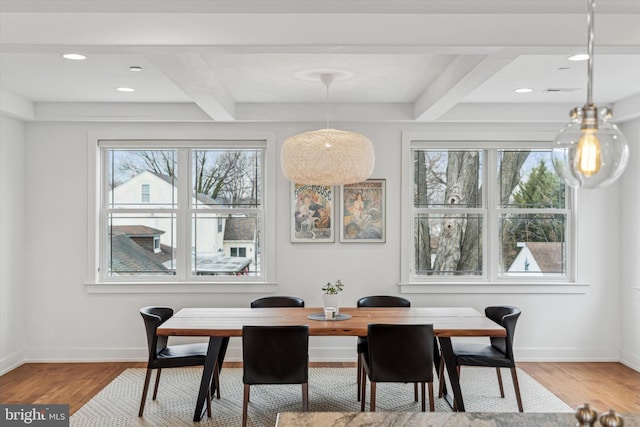 dining area with beamed ceiling, wood finished floors, and baseboards