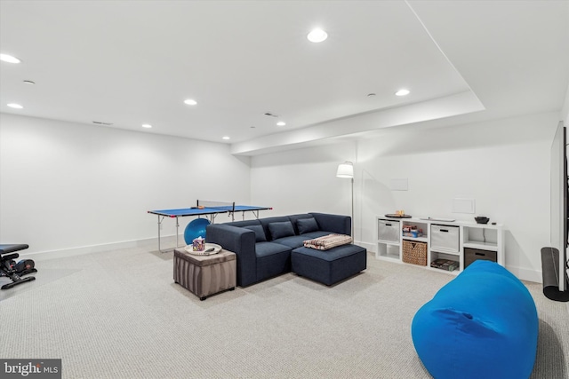 living area with recessed lighting, light colored carpet, and baseboards