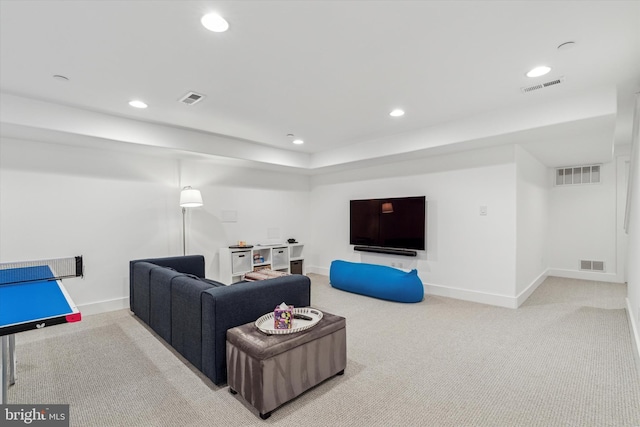 carpeted living area featuring visible vents and recessed lighting