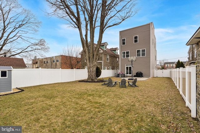 rear view of property featuring a lawn, a patio area, and a fenced backyard