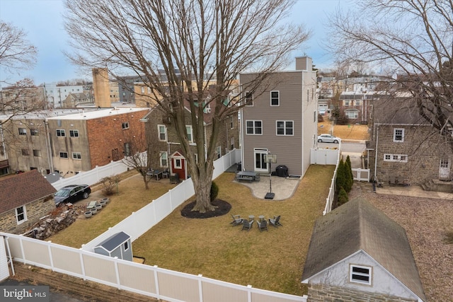 exterior space featuring a front yard, a fenced backyard, and a residential view