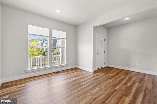 unfurnished room with hardwood / wood-style floors