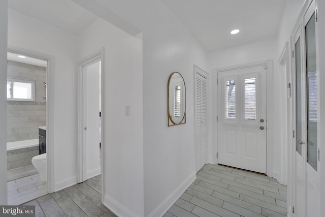 entryway with recessed lighting, baseboards, and wood finish floors