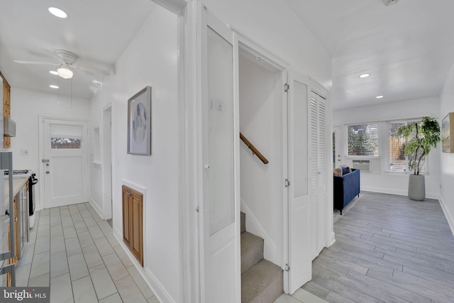 hallway featuring light wood-style flooring, stairs, baseboards, and recessed lighting